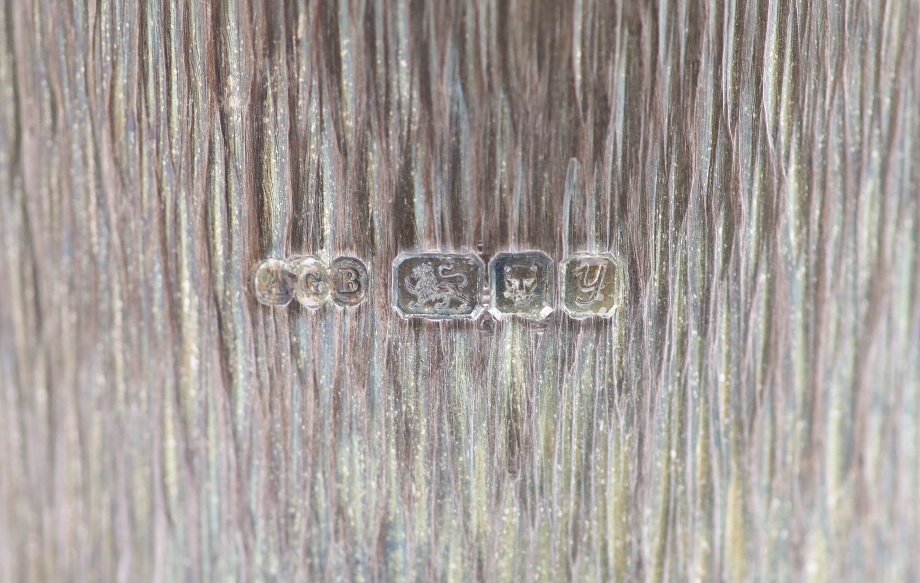 A pair of textured silver bottle coasters by Adrian Gerald Benney, with removeable silver mounted plastic liners